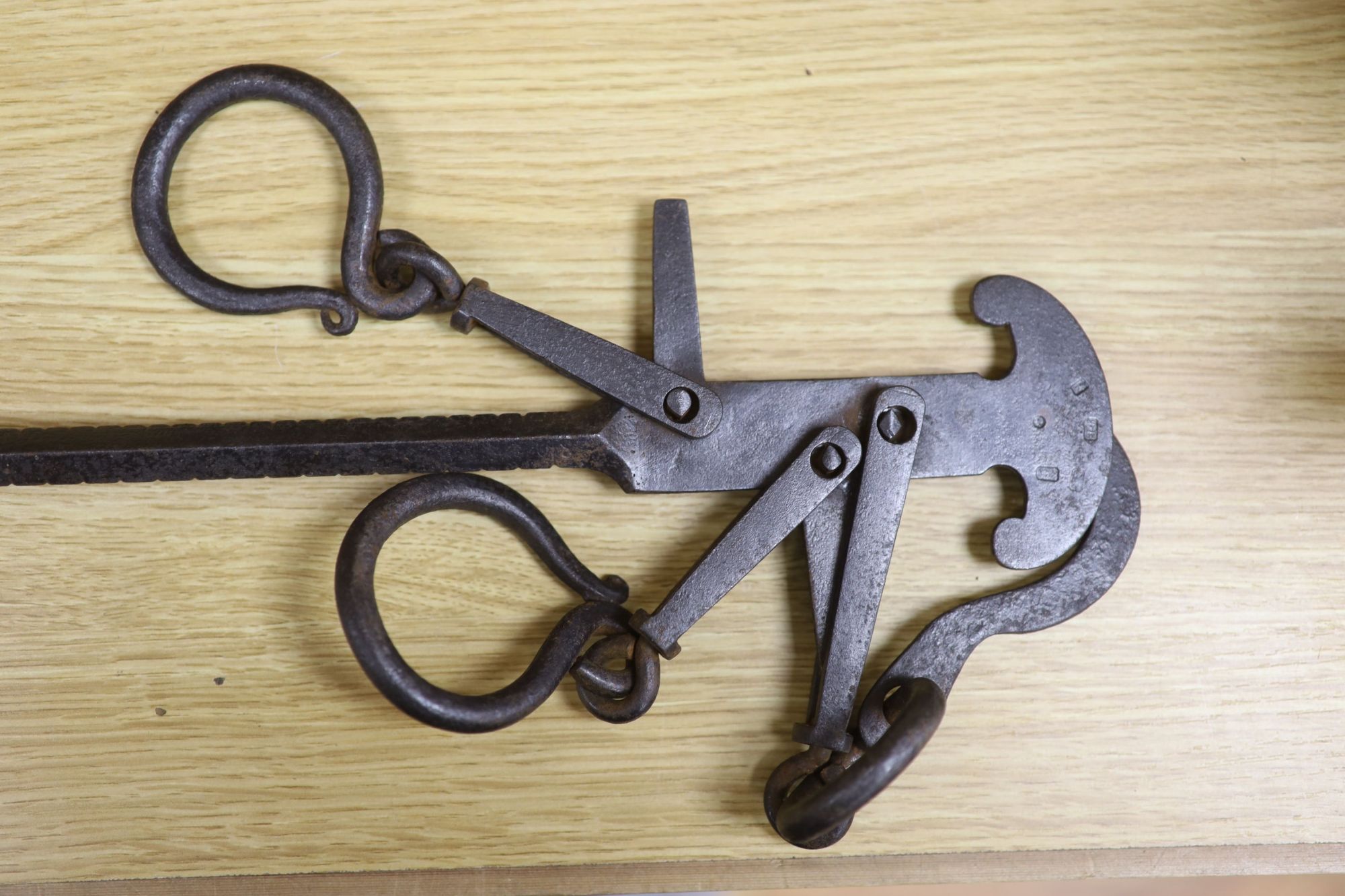 A set of 18th century Italian wrought iron stilliards, with a brass ball weight, length 94cm